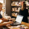 Shop owner checking Google Business Profile on laptop in real shop environment